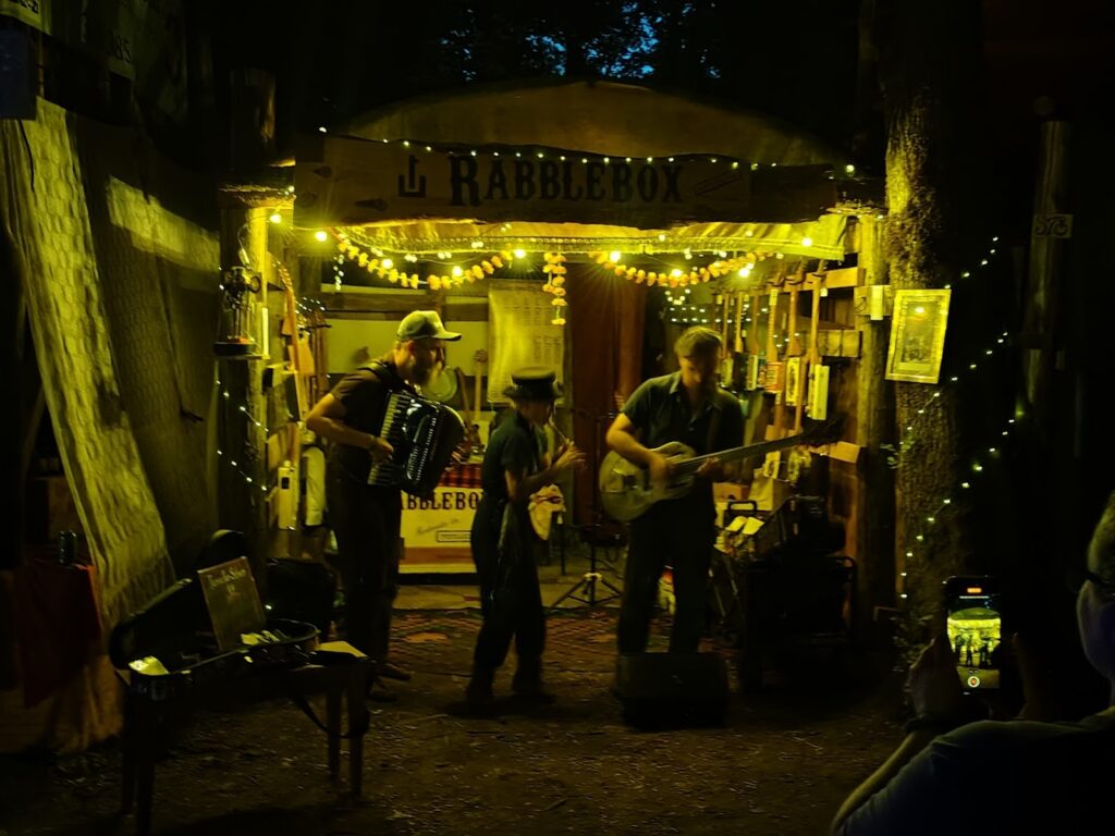 Three For Silver play on the path, 2025 Oregon Country Fair